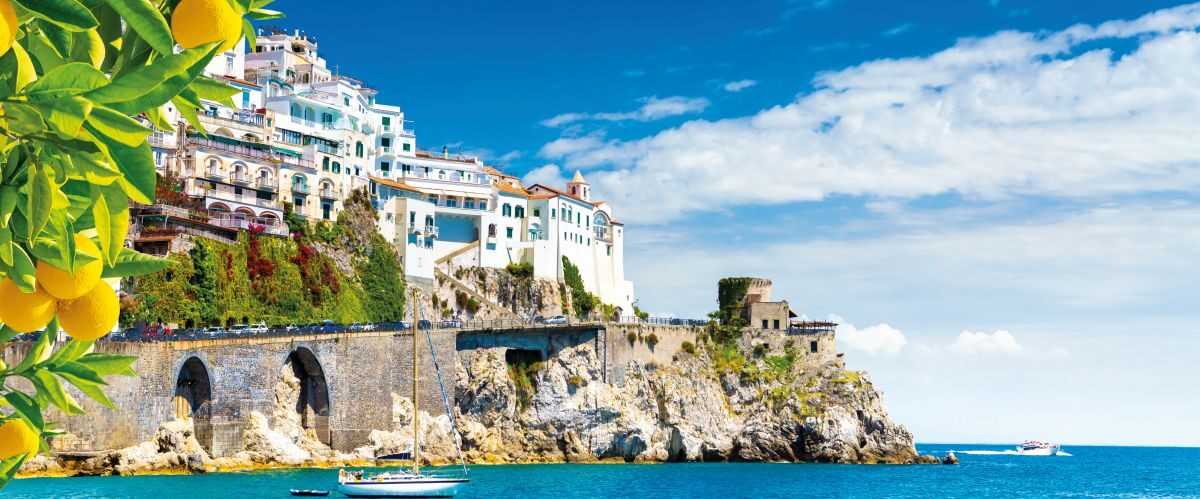Beautiful view of Amalfi on the Mediterranean coast with lemons in the foreground, Italy
