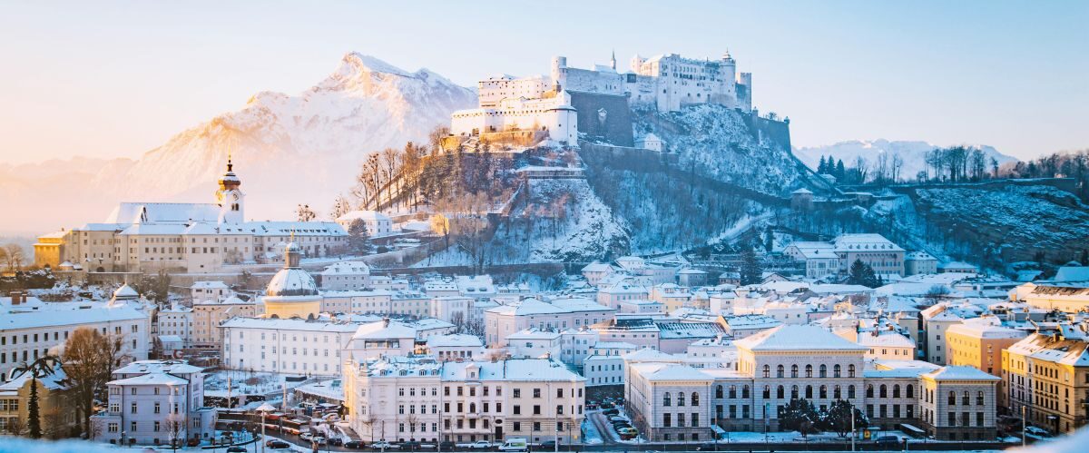Classic view of the historic city of Salzburg with famous Hohensalzburg Fortress and Salzach river in scenic morning light at sunrise on a beautiful c