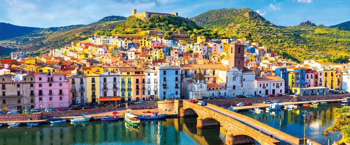 Aerial view of the beautiful village of Bosa with colored houses and a medieval castle. Bosa is located in the north-wesh of Sardinia, Italy. Aerial v