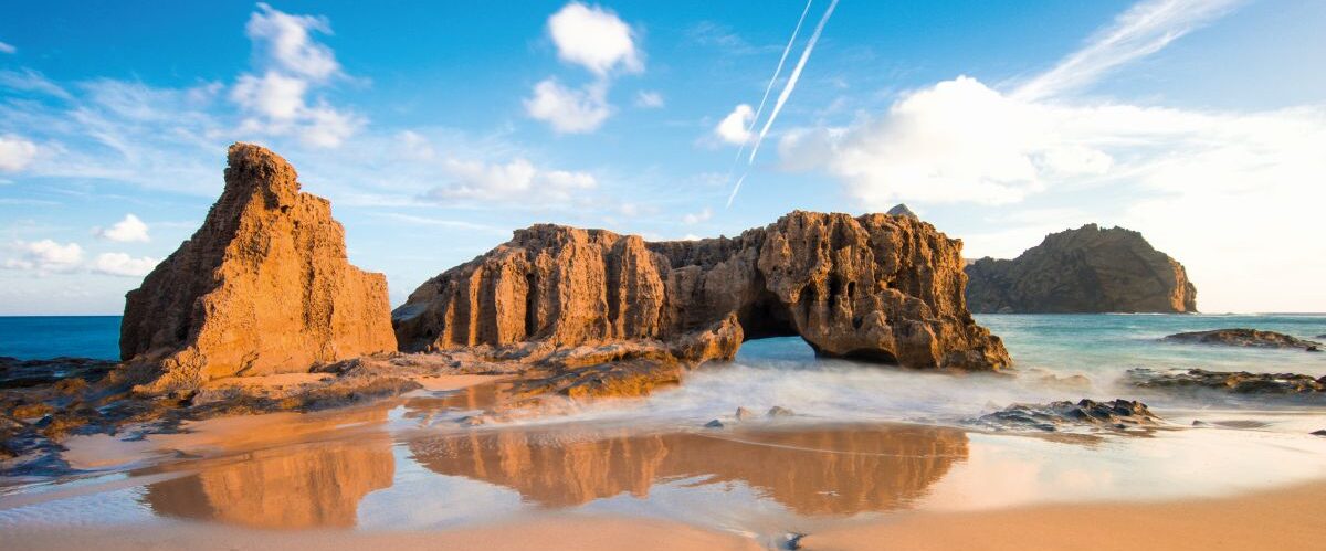 amazing beach landscape with rocks and blue sky